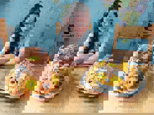 Young brunette girl with cat cake and cat soft toy